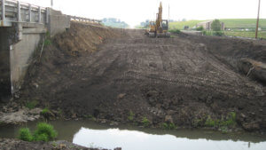 Grading and leveling of ground near the Massena bridge project.