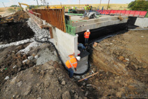Workers inspect progress on the bridge.