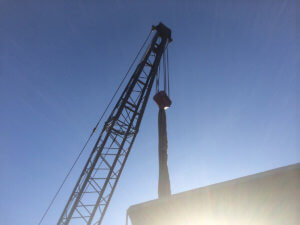 A view of a crane with sky behind it.
